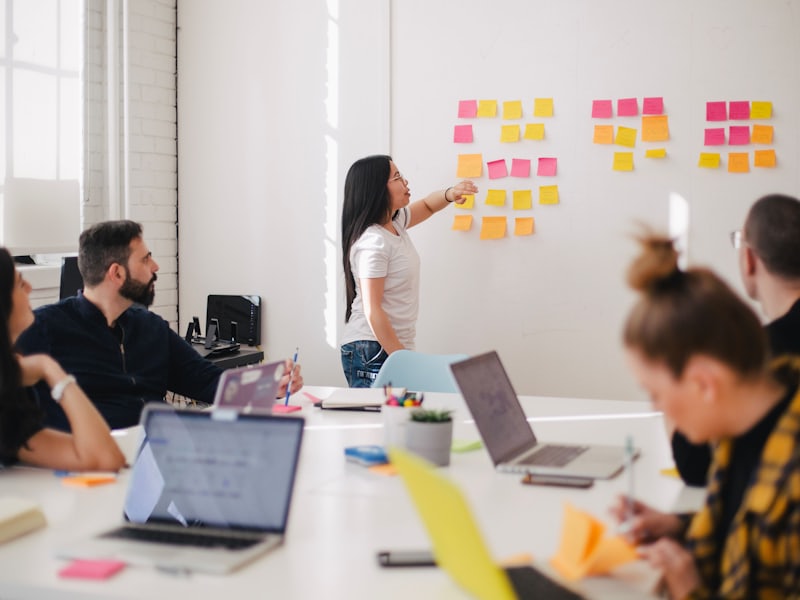 A team reviewing candidate notes on a wall of cards